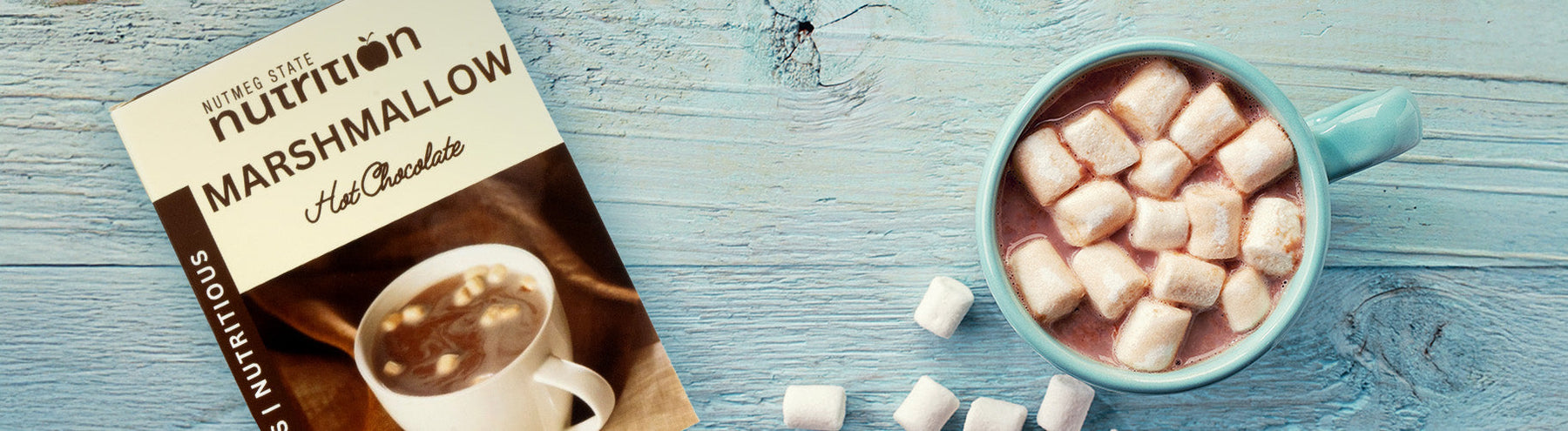 Nutmeg State Nutrition Hot Chocolate with Marshmallows in a cup next to its packaging.