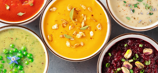An assortment of soups in bowls.