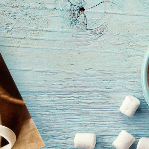 Nutmeg State Nutrition Hot Chocolate with Marshmallows in a cup next to its packaging.