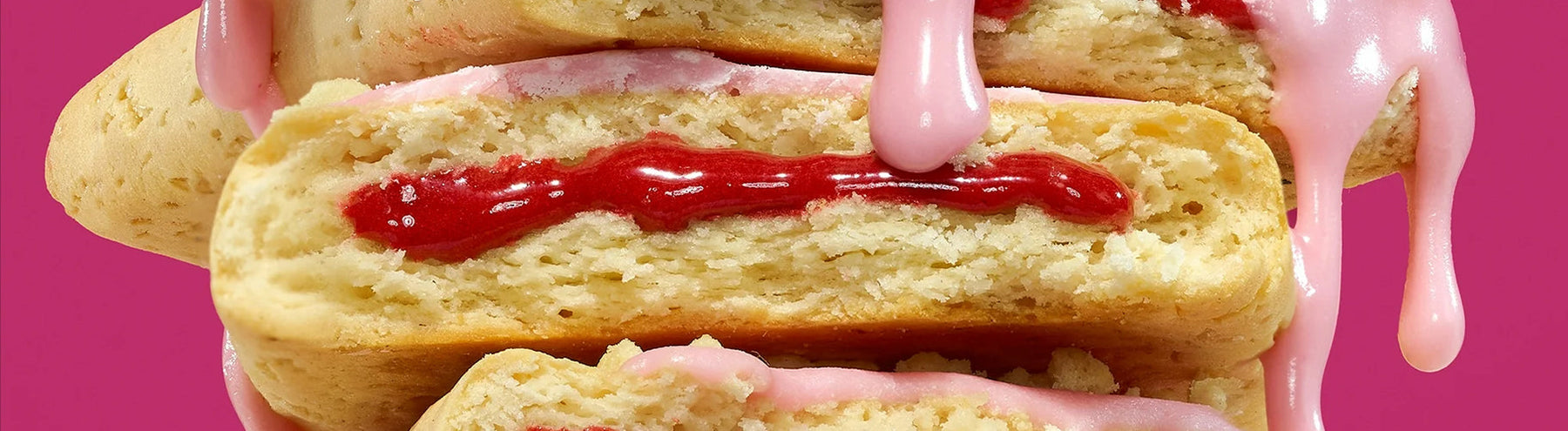 Close-up of Legendary Pop-Tarts stacked on top of one another with icing and filling dripping down.