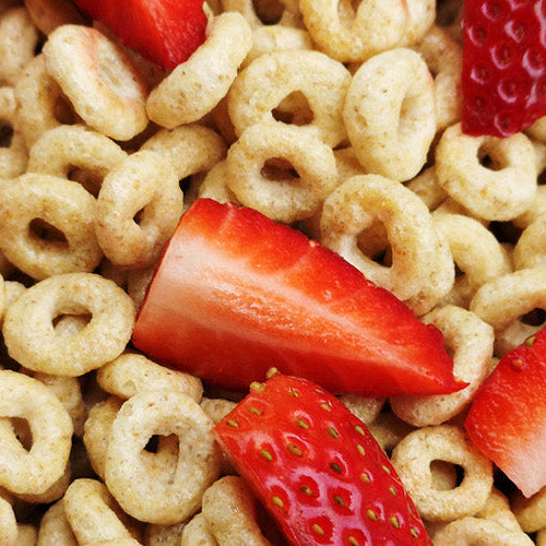 Bowl of Nutmeg State Nutrition low calorie protein cereal with strawberry slices.