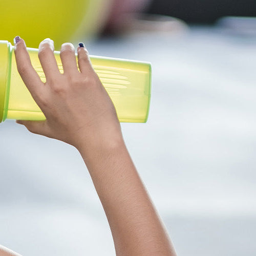 Woman drinking a protein shake at the gym.