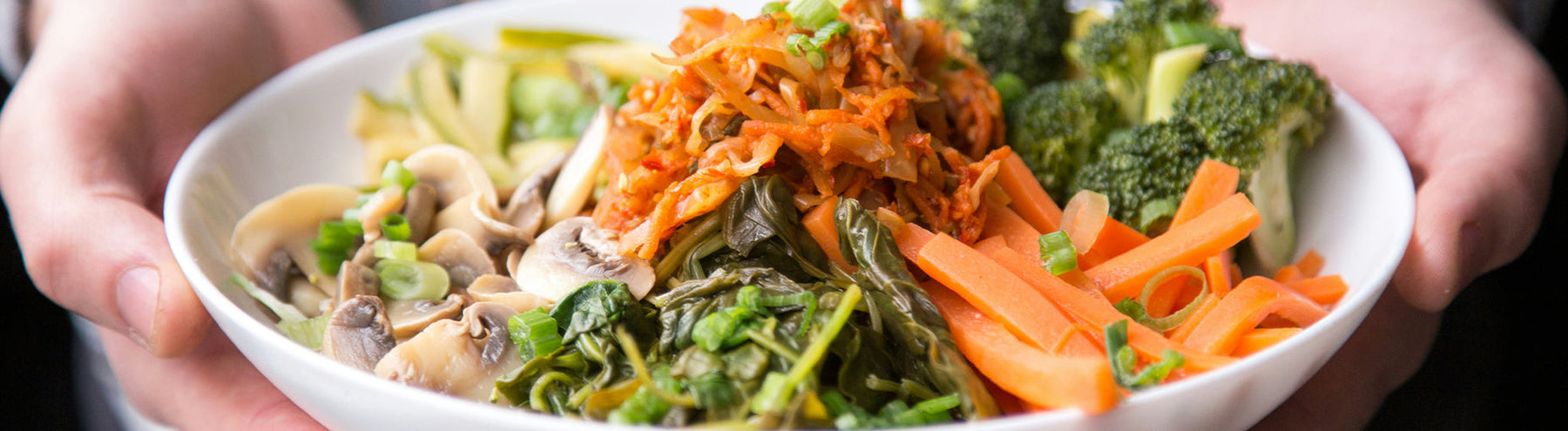 Dinner bowl with mushrooms, carrots, broccoli, leafy greens, and more.