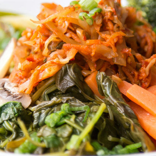 Dinner bowl with mushrooms, carrots, broccoli, leafy greens, and more.