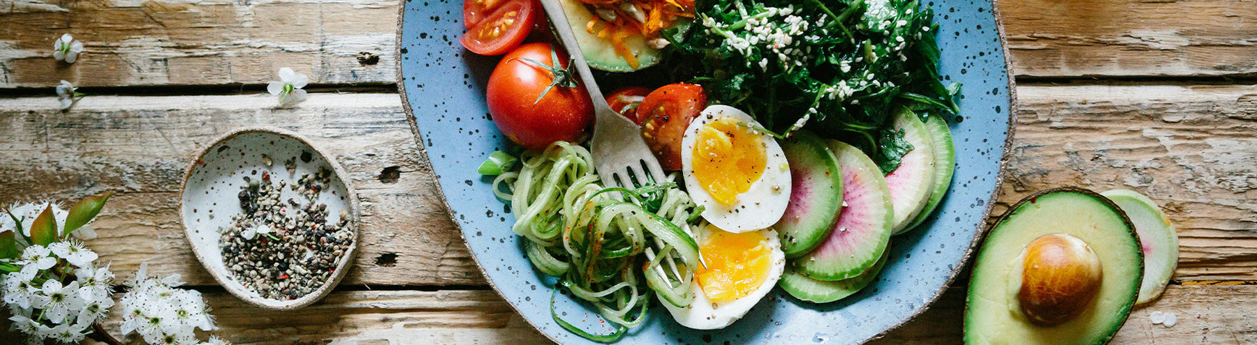 A plate full of healthy food, including a medium boiled egg, tomatoes, and spinach, ideal for a Semaglutide diet.