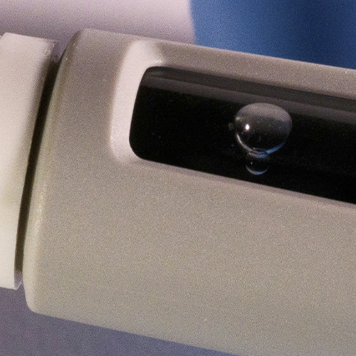 Close-up image of a semaglutide injection pen with a droplet forming at the needle tip.