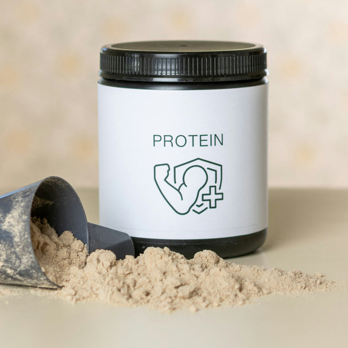 A scoop and spilled protein powder in front of a tub of protein powder with a flexed arm as the logo.